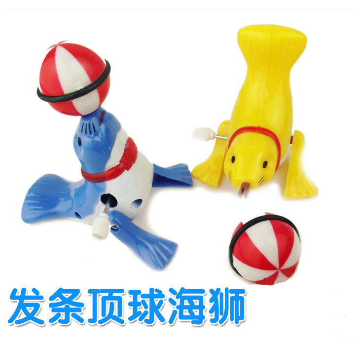 可旋转会走路球会转的上发条小海豚玩具,装上小球,上紧发条后,放在地